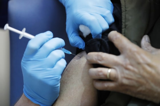 A nurse in London administers the Pfizer-BioNTech Covid vaccine in December 2020.