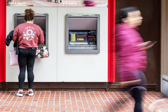 A customer uses an automated teller machine at a bank in San Francisco.