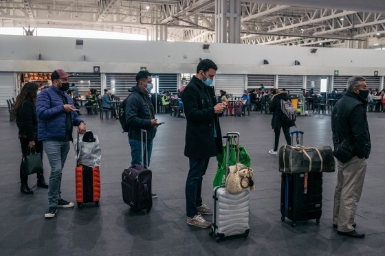 Travelers wait in line at Benito Juarez International Airport in Mexico City on Jan. 10, 2022.