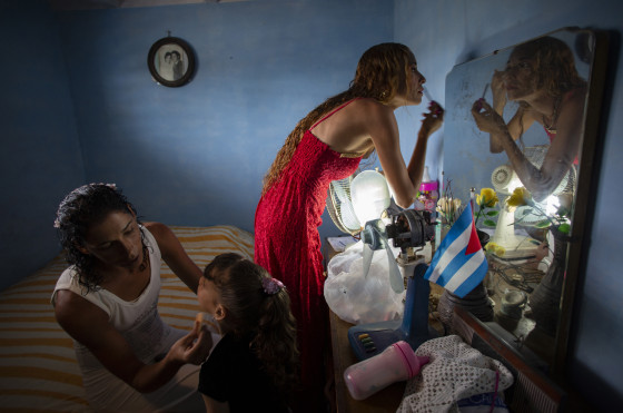 Liusba Grajales, left, puts makeup on her daughter Ainhoa as her partner, Lisset Diaz Vallejo, gets ready as they prepare to get married in Santa Clara, Cuba, on Friday.