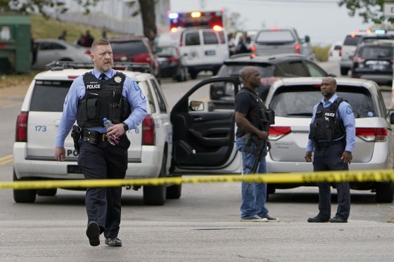 Law enforcement investigate the scene of a shooting at Central Visual and Performing Arts High School on Oct. 24, 2022, in St. Louis.