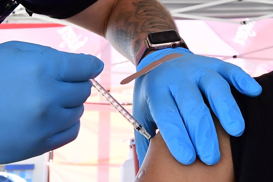 The Pfizer Covid-19 vaccine is administered at a pop-up clinic offering vaccines and booster shots in Rosemead, California on November 29, 2021. - President Joe Biden on Monday told Americans not to "panic" over the newly identified Covid variant Omicron and said he does not foresee new lockdowns or extending travel restrictions for now.