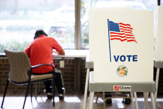 A voter casts their ballot at the Orange County Supervisor of Elections headquarters