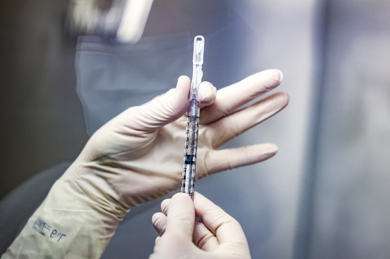 A pharmacy technician prepares a dose of the Johnson & Johnson Covid-19 vaccine for a clinical trial on Dec. 15, 2020, in Aurora, Colo.