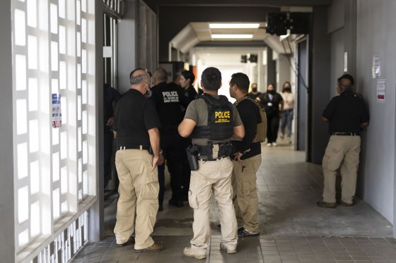 Federal agents wait for news of their injured colleagues outside the Rio Piedras Medical Center in San Juan, Puerto Rico, on Nov. 17, 2022.