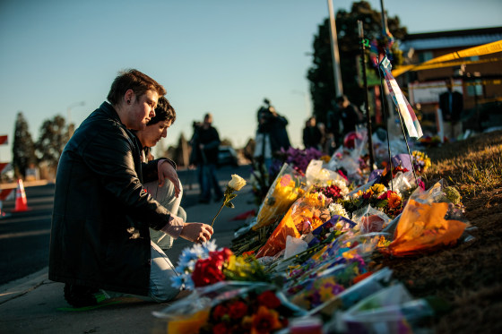 People leave flowers at the growing memorial outside Club Q, on Nov. 20, 2022 in Colorado Springs, Colo.
