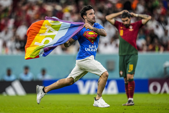 Image: A pitch invader runs across the field with a rainbow flag during the World Cup group H soccer match between Portugal and Uruguay, at the Lusail Stadium in Lusail, Qatar, on Nov. 28, 2022.