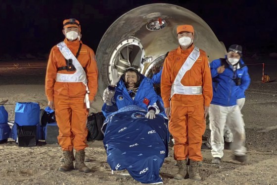 Astronaut Chen Dong waves as he sits outside the re-entry capsule of the Shenzhou-14 manned space mission after it landed successfully on Sunday in northern China’s Inner Mongolia Autonomous Region.