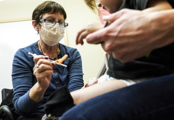 A nurse at a University of Washington Medical Center clinic in Seattle, gives a Pfizer Covid-19 vaccine shot to a 20-month-old child on June 21, 2022, in Seattle.