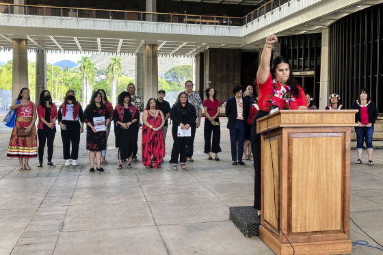 Makanalani Gomes, of AF3IRM, a feminist and decolonization organization, holds a fist in the air as she discusses a report on missing and murdered Native Hawaiian women on Dec. 14, 2022 in Honolulu.