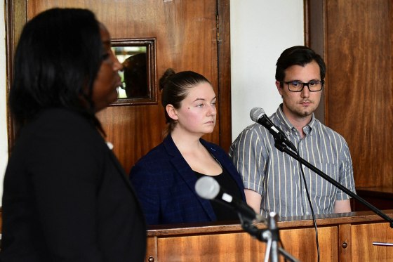 2M3388G American couple Nicholas Spencer and his wife, Mackenzie Leigh Mathias Spencer, both 32, stand in the dock at Buganda road court, where they were charged with torturing a ten year old John Kayima and state prosecutor objected to their application saying that the two have been illegally in Uganda after their work permits expired, in Kampala, Uganda, December 14, 2022.