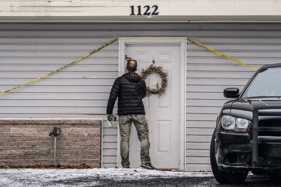 Image: A worker leaves the crime scene at the site <a href=