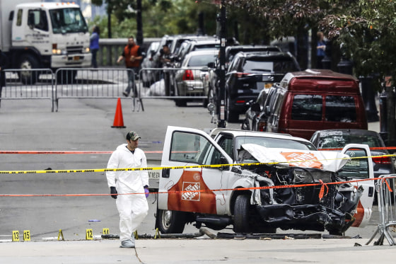 Investigators work around the wreckage of a Home Depot pickup truck on Nov. 1, a day after it was used in an attack in New York.