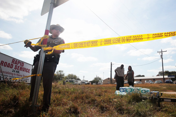 A police officer ties crime scene tape near the First Baptist Church of Sutherland Springs