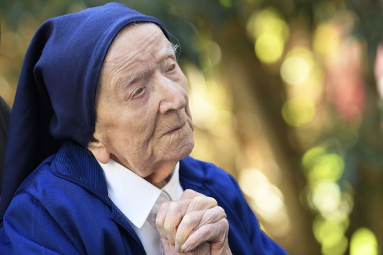 In this file photo taken on February 10, 2021, Sister Andre, Lucile Randon in the registry of birth, the eldest French and European citizen, prays in a wheelchair, on the eve of her 117th birthday, in an EHPAD (Housing Establishment for Dependant Elderly People) in Toulon, southern France, where she has been living since 2009. - The world's oldest known person, Lucile Randon, known as Sister Andre, has died aged 118, her spokesman said on January 17, 2023. Randon was born in southern France on February 11, 1904, when World War I was still a decade away.