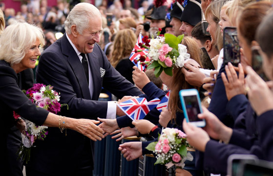 Britain's King Charles III and Camilla, the queen consort, greet the crowd as they arrive at Hillsborough Castle in Belfast, during his visit to Northern Ireland in September.