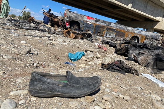 Image: The wreckage of a burnt passenger bus at Bela in Lasbela district of Pakistan's Balochistan province on Sunday.