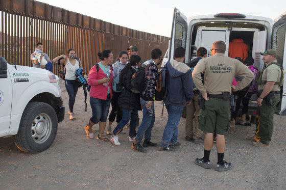 Central American asylum seekers are detained by the U.S. Border Patrol after they crossed into the United States from Mexico near Yuma, Ariz.
