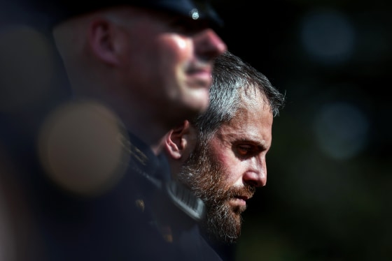 D.C. Metropolitan Police Officer Michael Fanone listens as President Joe Biden speaks in the Rose Garden of the White House on Aug. 5, 2021.