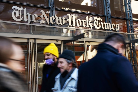 People walk by the New York Times building in New York