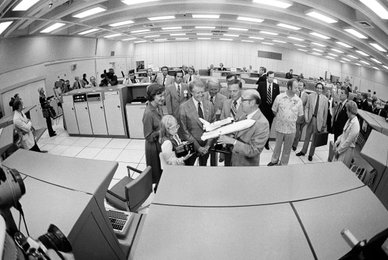 NASA administrator Dr. Robert Froscoch, right, shows a model of the space shuttle to President Jimmy Carter, Rosalynn Carter and  Amy Carter, during a visit to Cape Canaveral