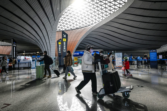 Passengers prepare to check in at Daxing International airport in Beijing on Jan. 19, 2023.