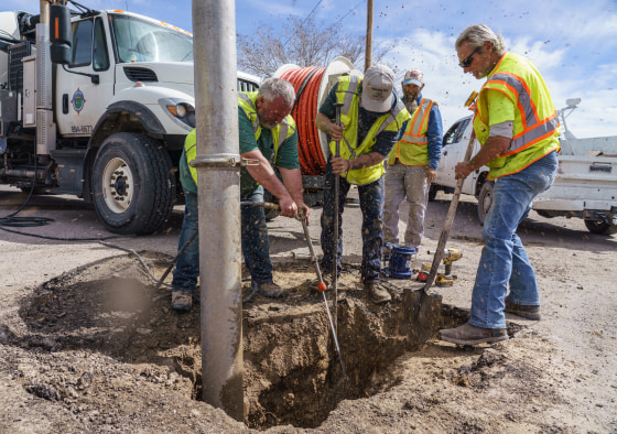 City workers repair a pipe that broke in Truth or Consequences, New Mexico