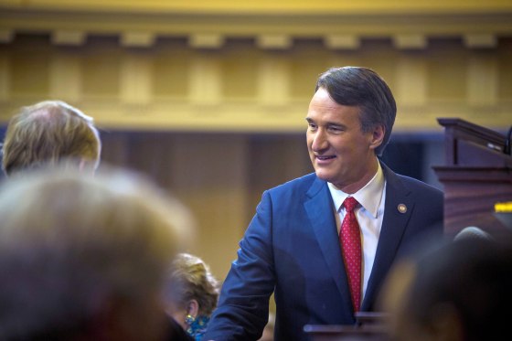 Gov. Glenn Youngkin shakes hands with his cabinet before delivering his State of the Commonwealth address in Richmond, Va.