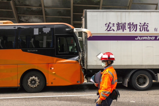 An ambulance worker inspects an accident on a highway in Hong Kong