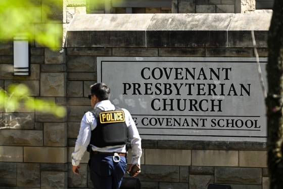 Image: A police officer walks by an entrance to The Covenant School after a shooting in Nashville, Tenn. on March 27, 2023.