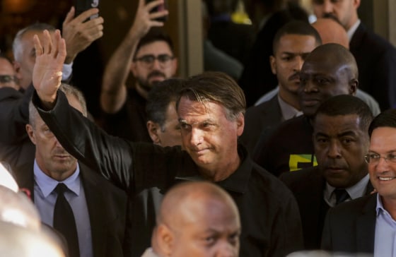 Brazil's former President Jair Bolsonaro greets supporters outside the Liberal Party's headquarters in Brasilia on March 30, 2023.