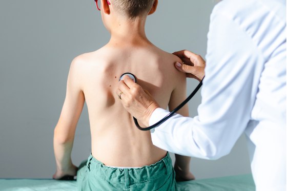 Doctor checking boy's lungs With a stethoscope