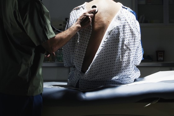 Doctor examining patient with stethoscope