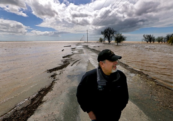 Mark Grewel on a farm road that was flooded in Lemoore, Calif