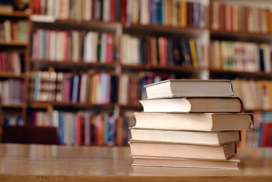 Close up of books on desk in library.

Books