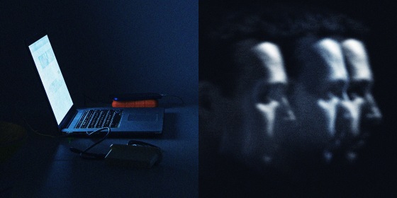 A photo of a computer and hard drives in a dark room, and a 