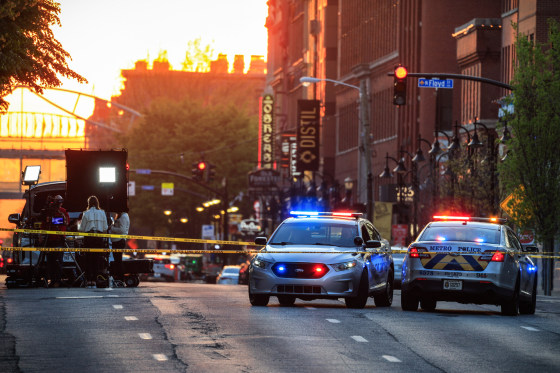 Police cars and cordon tape block Main Street near the Old National Bank after a mass shooting in Louisville, Ky., on April 10, 2023.