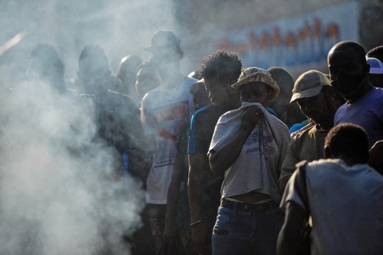 People look at bodies in the street after gang-related violence in the capital of Port-au-Prince, Haiti on April 24, 2023.