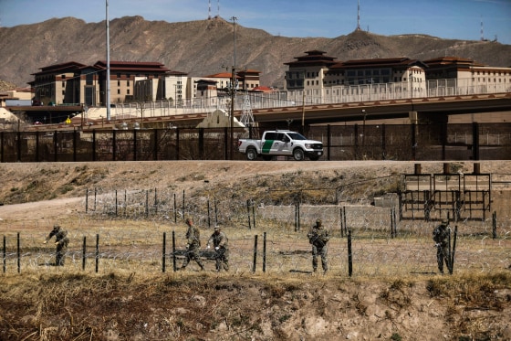 National Guard agents place a barbed wire wall on the banks of the Rio Grande in El Paso, Texas, on the border with Ciudad Juarez, Chihuahua State, Mexico, on March 8, 2023.
