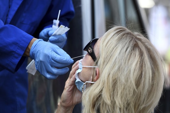 A medical technician administers a COVID-19 in New York
