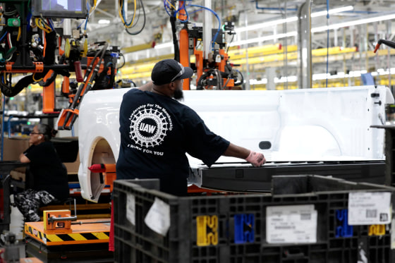 A worker works on the assembly of a Ford truck in Dearborn, Mich. 