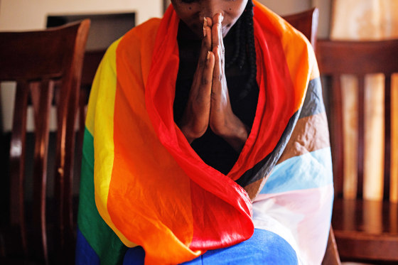 A member of the LGBTQ community prays during an evangelical church service in Kampala, Uganda