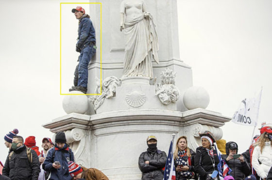 Bruno Joseph Cua on top of a Statue at the Peace Circle on January 6, 2021.