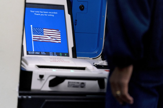 A voter submits their ballot at an early voting location in Alexandria, Va., Monday, Sept. 26, 2022. Election officials in Virginia have announced plans to withdraw the state from a bipartisan effort aimed at ensuring accurate voter lists and combating fraud that has been ensnared in conspiracy theories that have erupted since the 2020 presidential election.
