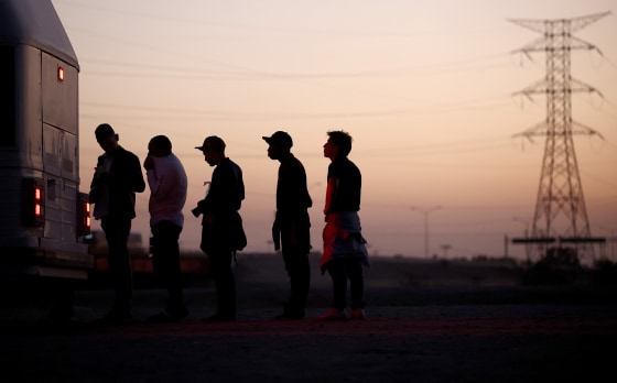 Immigrants seeking asylum wait to board a bus to a U.S. Border Patrol processing center, after crossing into Arizona from Mexico, on May 11, 2023.