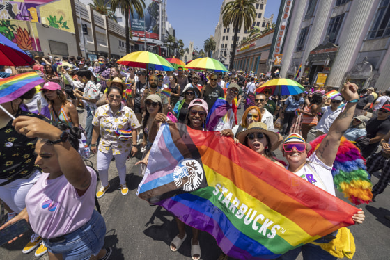 Marchers with Starbucks pass through the landmark intersection of Hollywood and Highland during the annual Pride Parade in Los Angeles