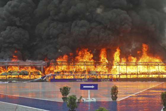 Smoke billows from burning illegal narcotics during a ceremony marking International Day against Drug Abuse and Illicit Trafficking on the outskirts of Yangon, Myanmar, Monday, June 26, 2023.