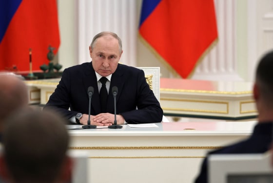 Vladimir Putin meets with servicemen at the Kremlin in Moscow
