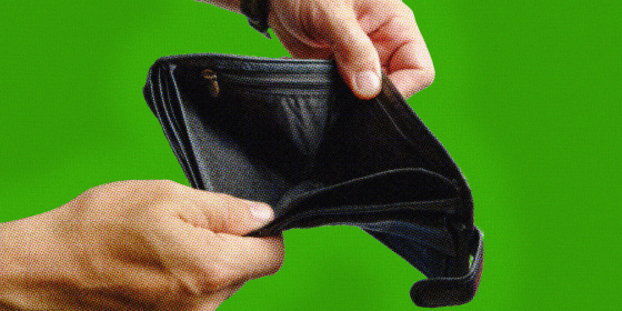 Hands holding empty wallet over a green background