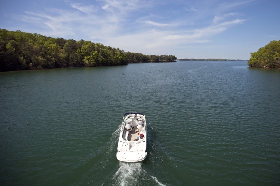 A boat passes along Lake Lanier, April 23, 2013, in Buford, Ga. Fashion designer Tameka Foster, the ex-wife of R&B singer Usher, is calling to drain Lake Lanier, Georgia's largest lake, where her son was fatally injured 11 years ago. Kile Glover, her 11-year-old son with Bounce TV chairman Ryan Glover, died in July 2012 after a personal watercraft struck the boy as he floated in an inner tube on the lake.